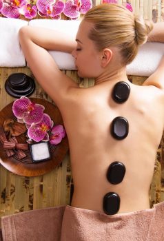 beautiful-woman-relaxing-spa-salon-with-hot-stones-body-beauty-treatment-therapy